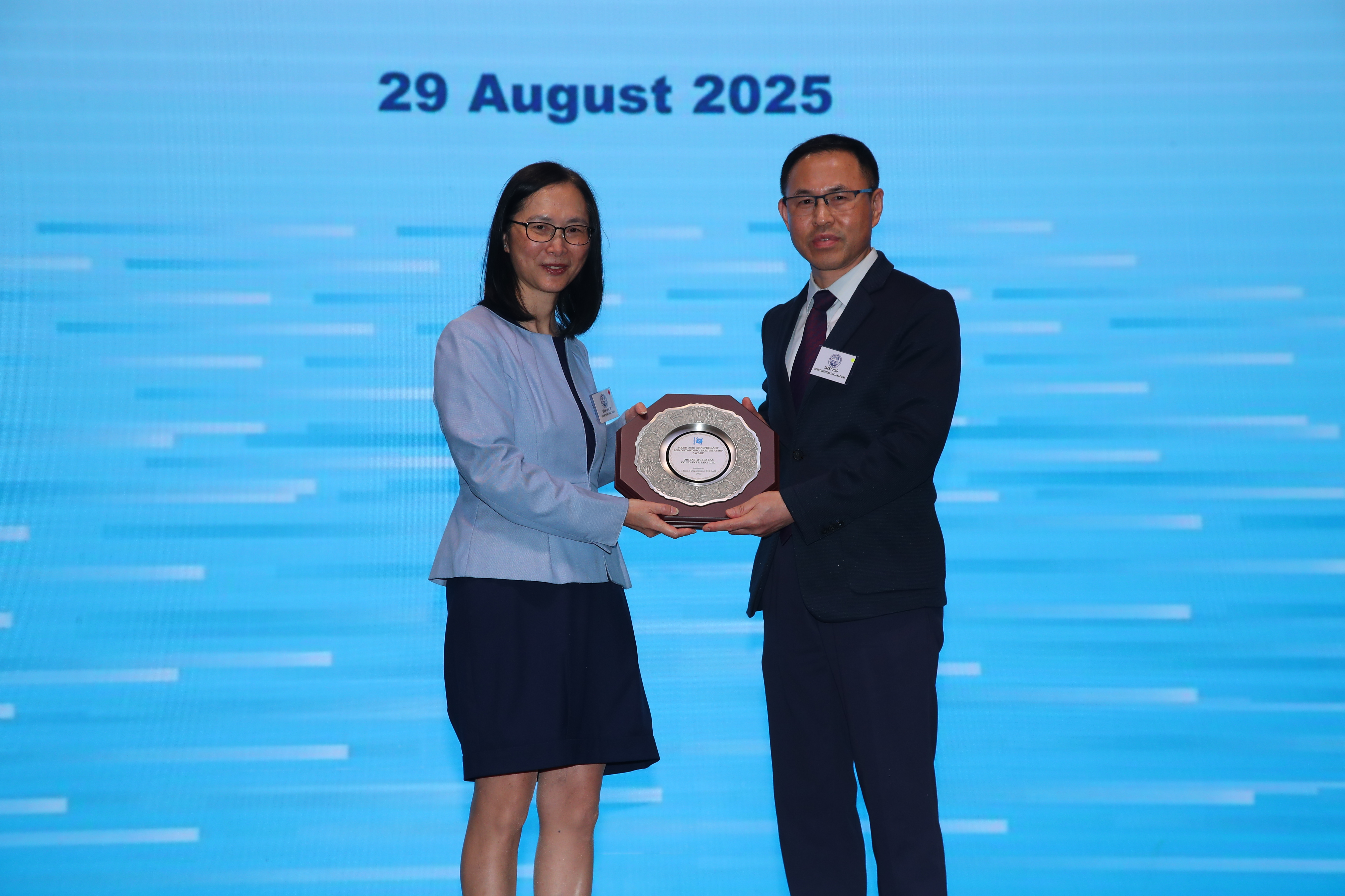 A person and person holding a plaque    AI-generated content may be incorrect.